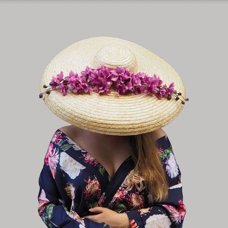 Floppy Hat in Natural Straw with a Branch of Fuchsia Flowers. Shania Model