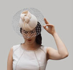 Sinamay Headdress with a Beige Veil. Phillippa Model 90.910€ #94004PHILLIPPA